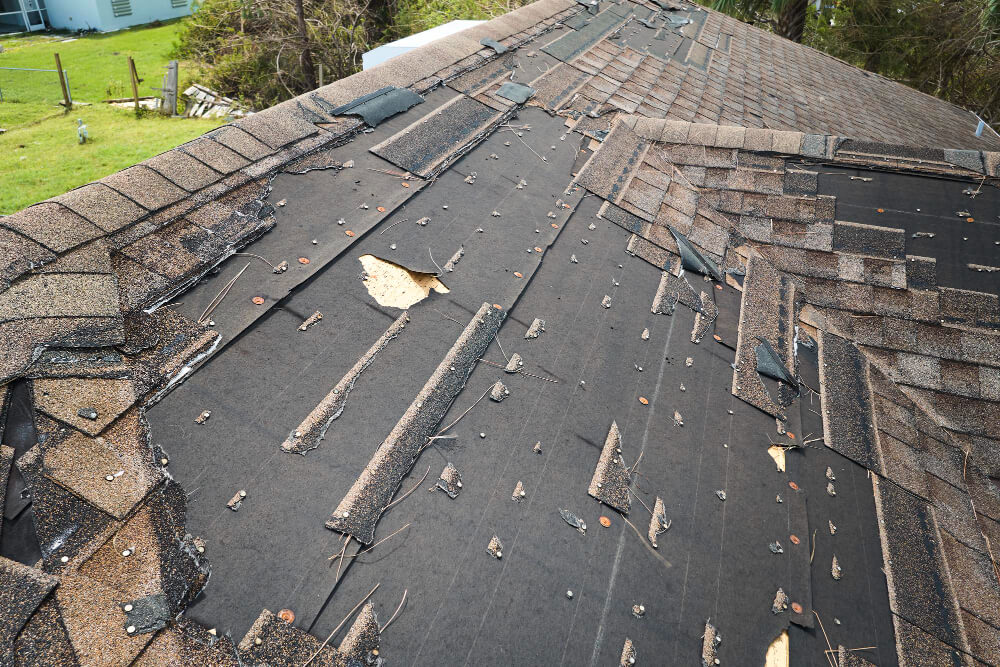  Damaged House Roof With Missing Asphalt Shingles 